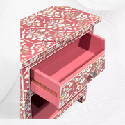 Elegant pink bedside table with storage and pearl inlay detail