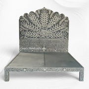 Decorative bed with intricate patterns on a white background
